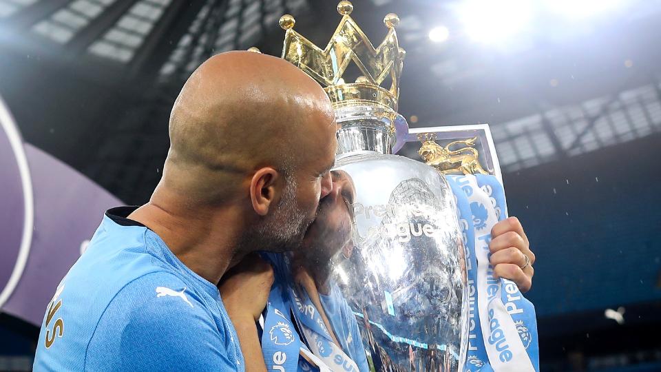 Pep Guardiola celebrates with Premier League trophy in 2022